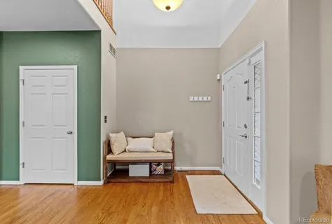 a living room with furniture kitchen view and a large window