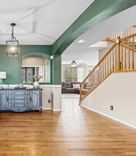 a kitchen with granite countertop a refrigerator and cabinets