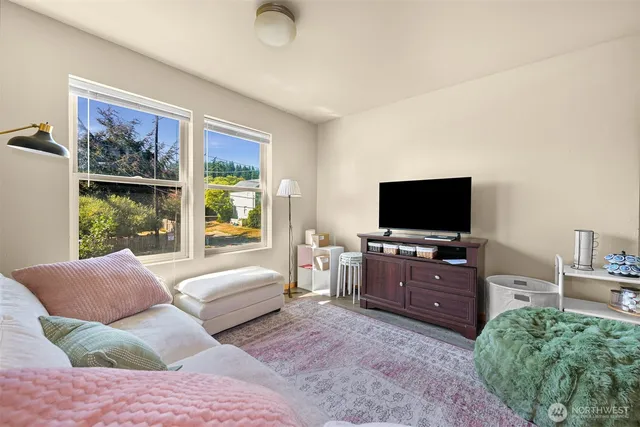 a bedroom with furniture and a flat screen tv