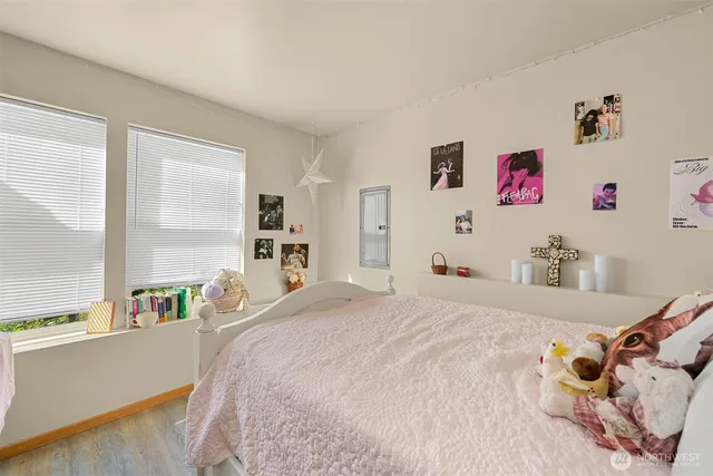 a bedroom with a bed and a large window