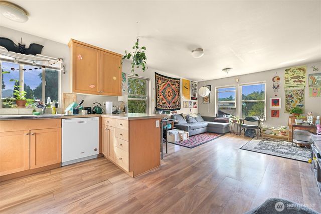 a living room with furniture dining area and a large window