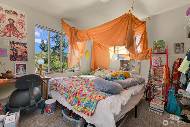 a bedroom with a bed and a window