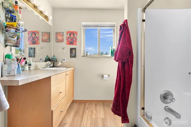 a bathroom with a sink vanity and a mirror