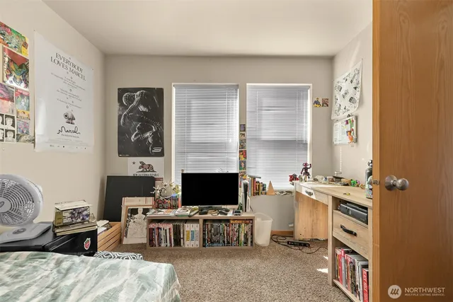 a view of a livingroom with workspace and a window