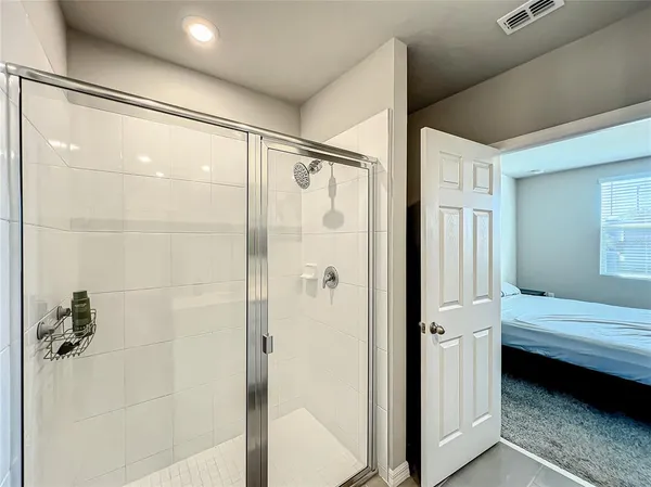 a en suite bathroom with a shower and a sink