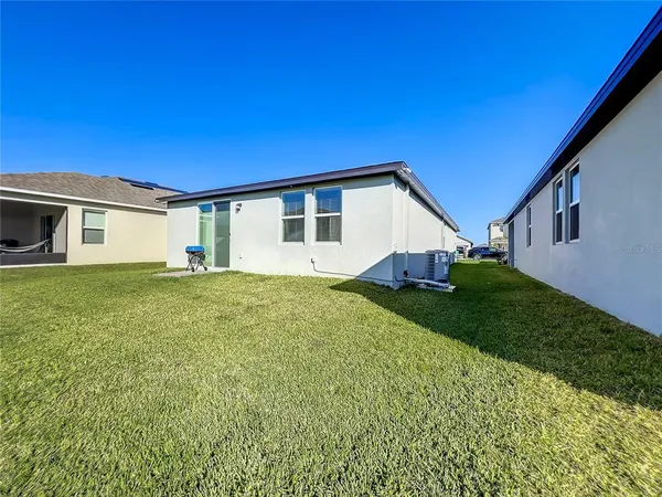 a aerial view of a house with a yard and table