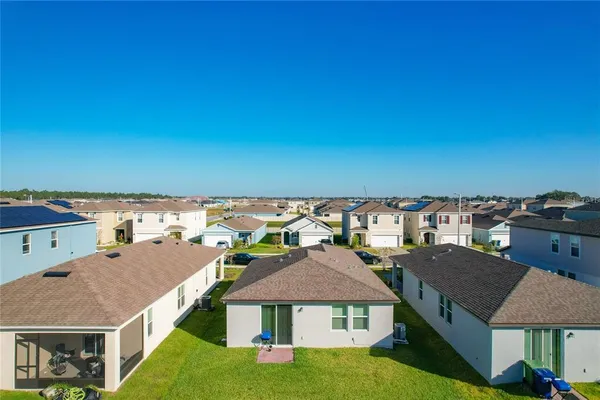 an aerial view of residential houses with outdoor space