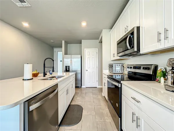 a kitchen with stainless steel appliances a stove sink and cabinets