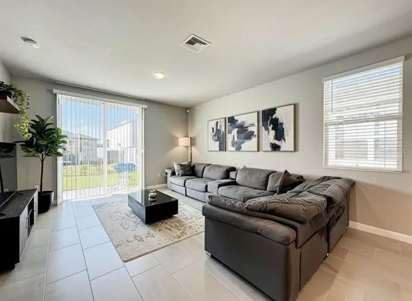 a living room with furniture and a large window