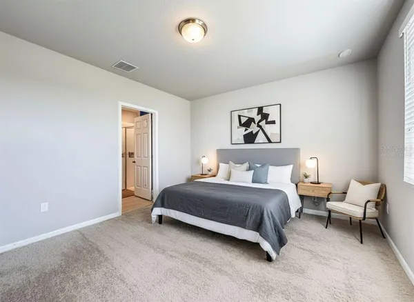 a spacious bedroom with a bed and a couch