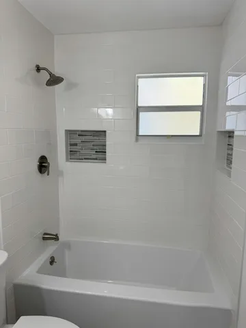 a bathroom with a bathtub and a shower