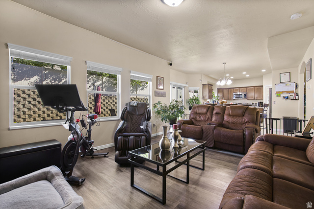 2005 Redtail Way Layton, UT 84040 - Photo 15 of 37 Open-concept living area featuring wood-finish flooring and multiple windows with white blinds