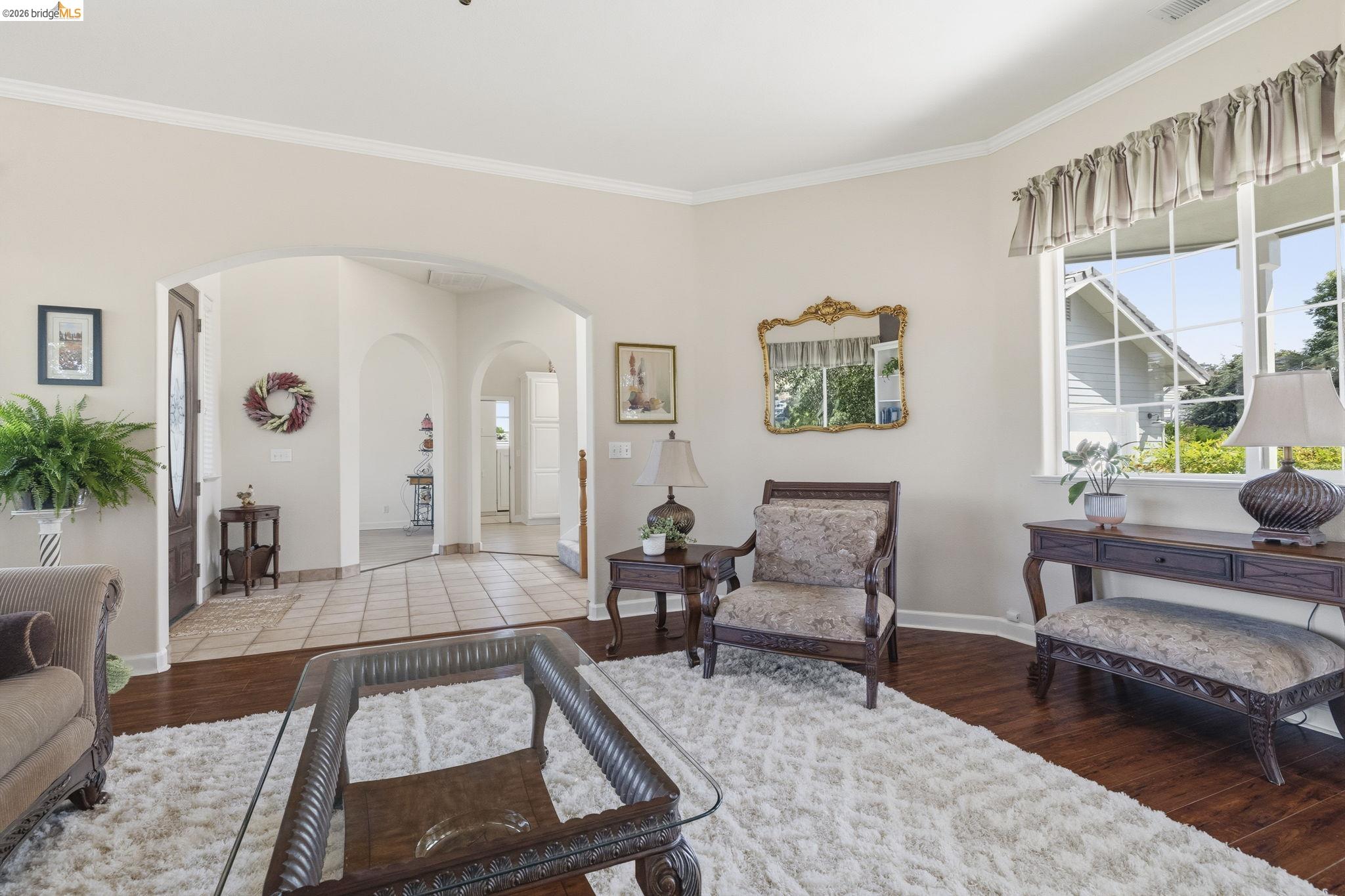 6242 Bluff View Road Copperopolis, CA 95228 - Photo 9 of 59 Spacious Living Room with dark wood floors and a cozy gas burning fireplace and built in shelving