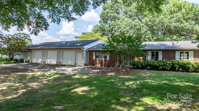 a view of a house with a tree in front