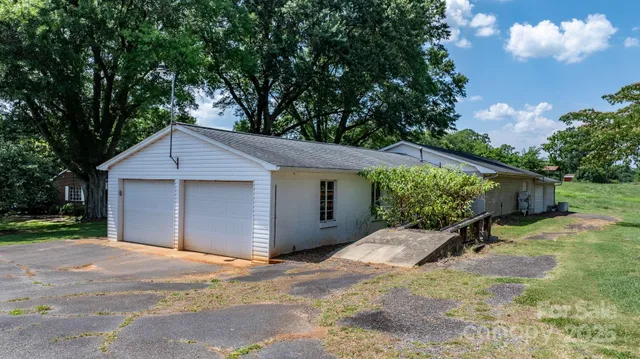 a view of a house with a yard and tree s