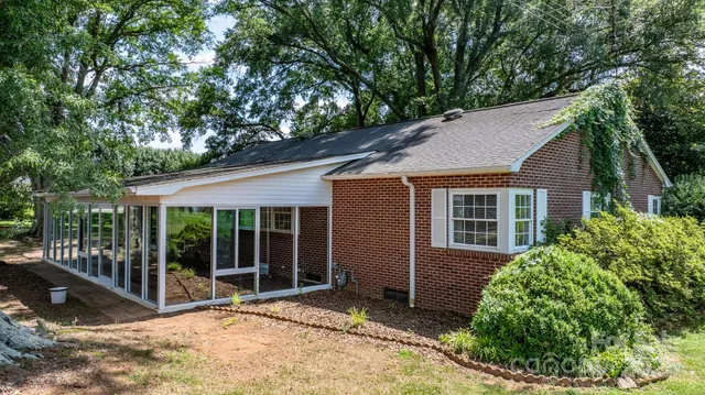 a view of a house with a porch and potted plants