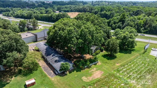 an aerial view of residential house with an outdoor space and seating
