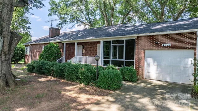 a view of a house with a yard and plants