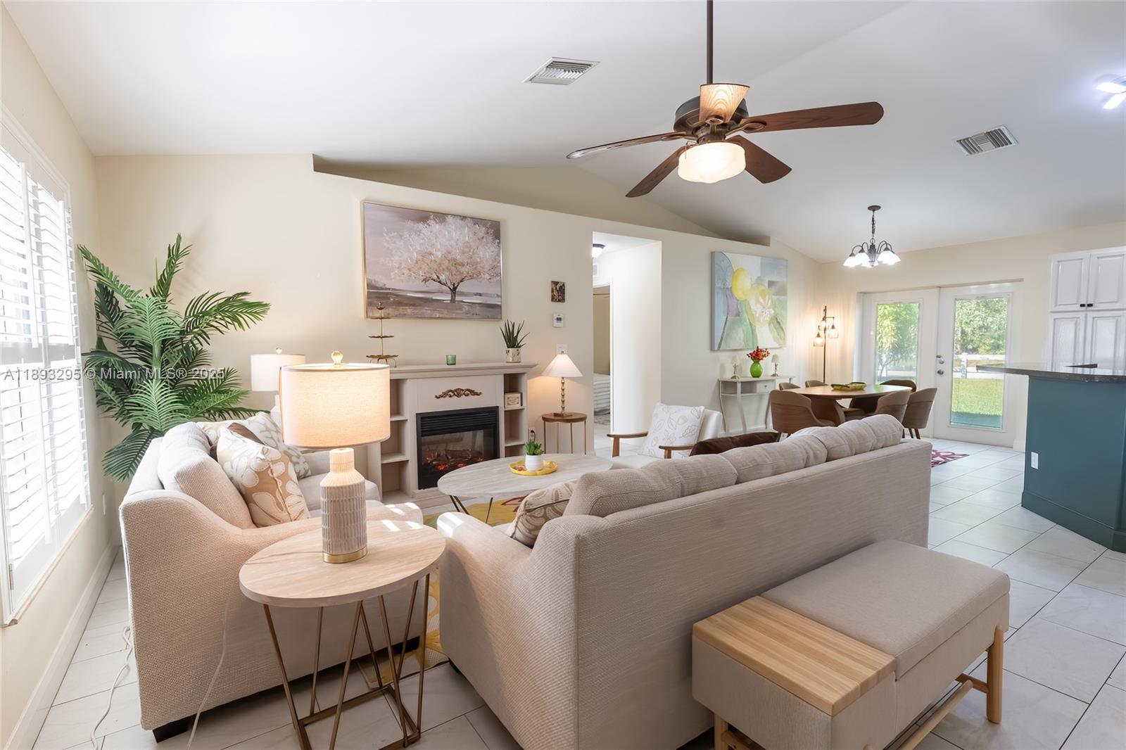 36 Quail Roost Road Lake Placid, FL 33852 - Photo 18 of 48 a living room with furniture a fireplace and a chandelier