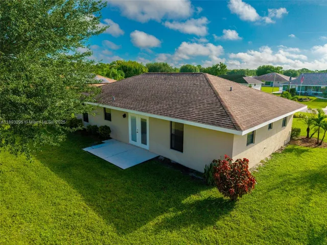 a aerial view of a house with a yard and plants