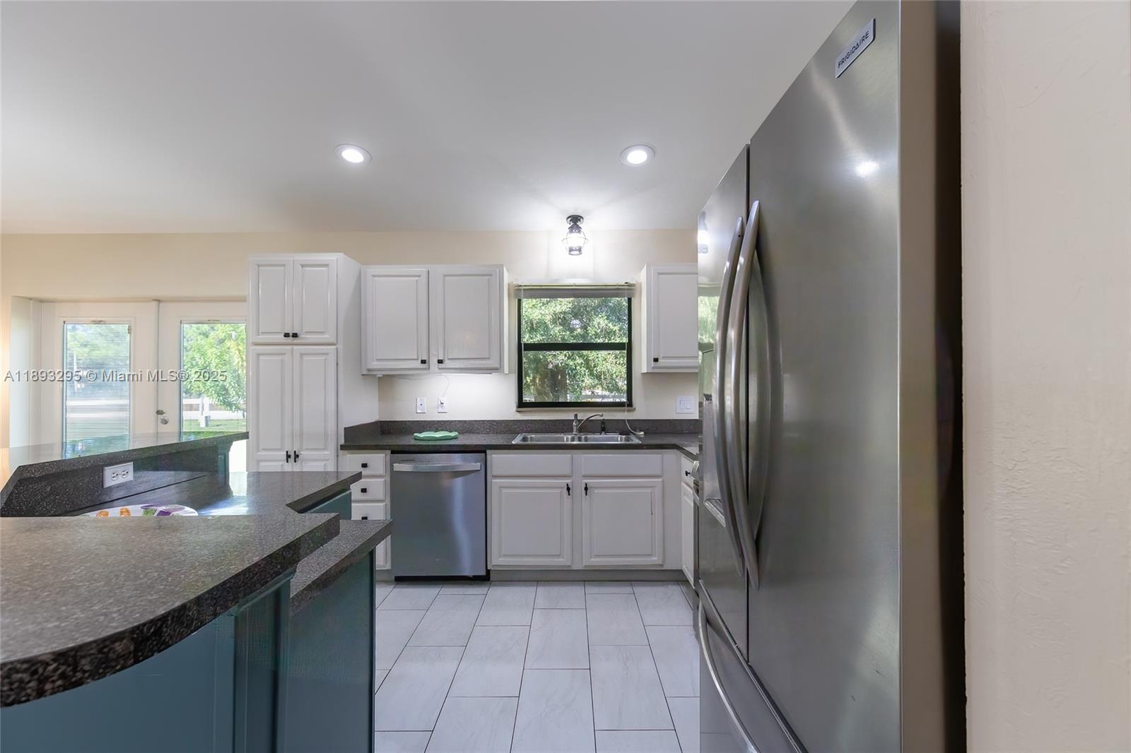 36 Quail Roost Road Lake Placid, FL 33852 - Photo 23 of 48 a kitchen with stainless steel appliances granite countertop a sink stove and refrigerator