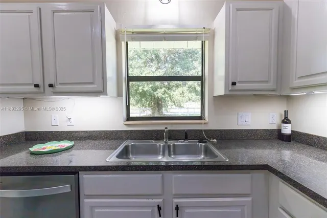 a kitchen with a sink and cabinets