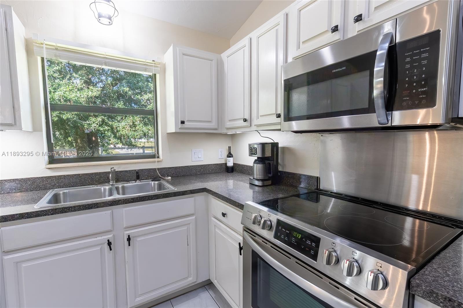 36 Quail Roost Road Lake Placid, FL 33852 - Photo 27 of 48 a kitchen with granite countertop white cabinets stainless steel appliances and a sink