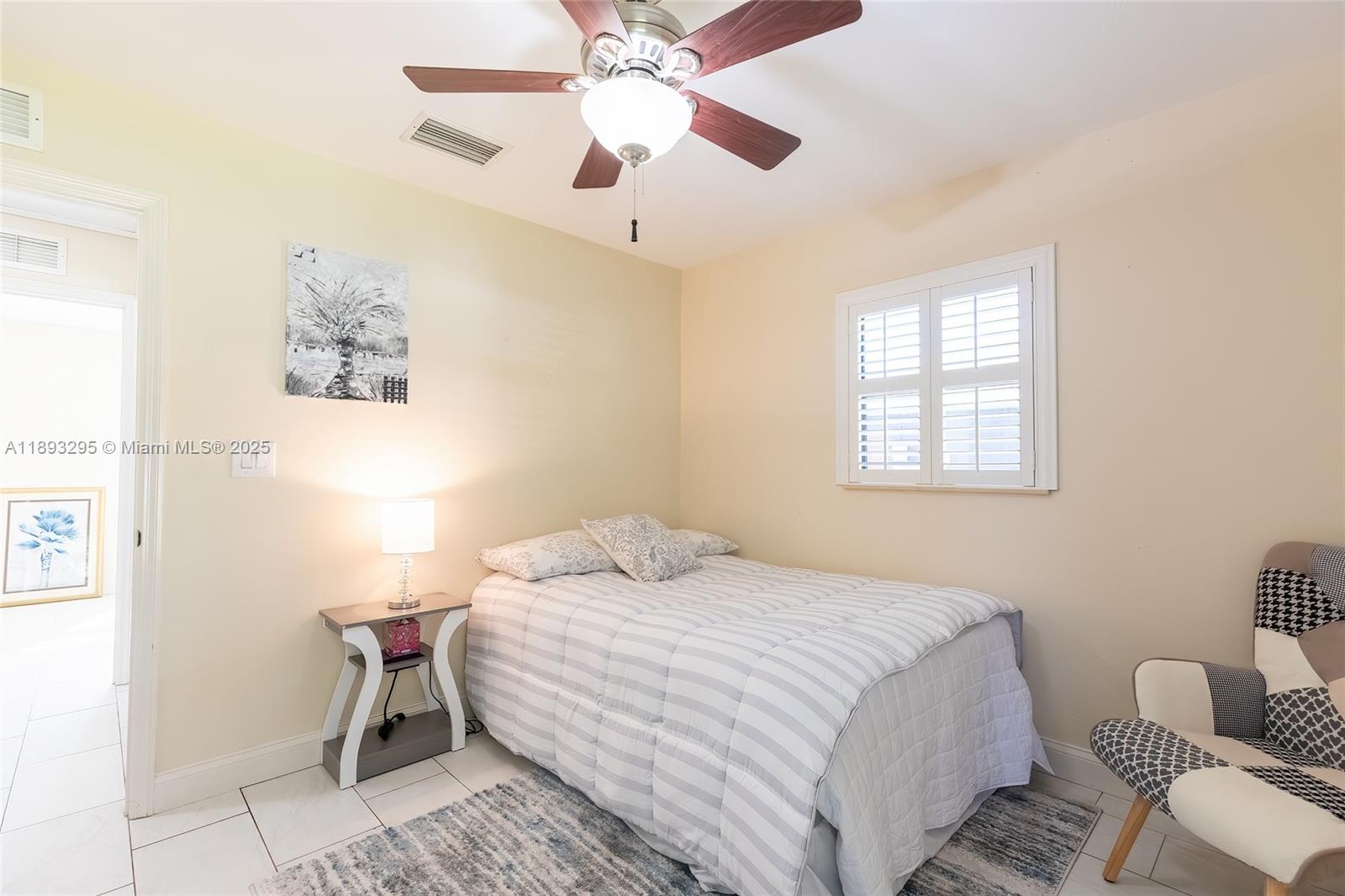 36 Quail Roost Road Lake Placid, FL 33852 - Photo 35 of 48 a bedroom with a bed and a chandelier