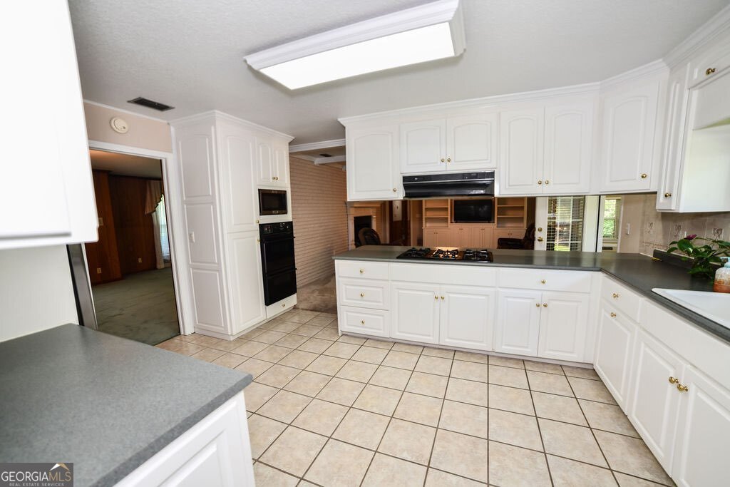 39 Adams Street Jesup, GA 31545 - Photo 23 of 49 a kitchen with stainless steel appliances a refrigerator sink and microwave