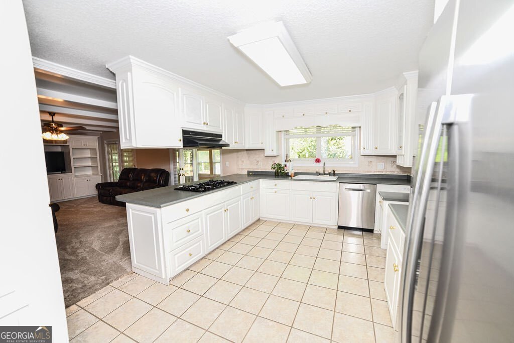 39 Adams Street Jesup, GA 31545 - Photo 25 of 49 a kitchen with stainless steel appliances a refrigerator sink and cabinets