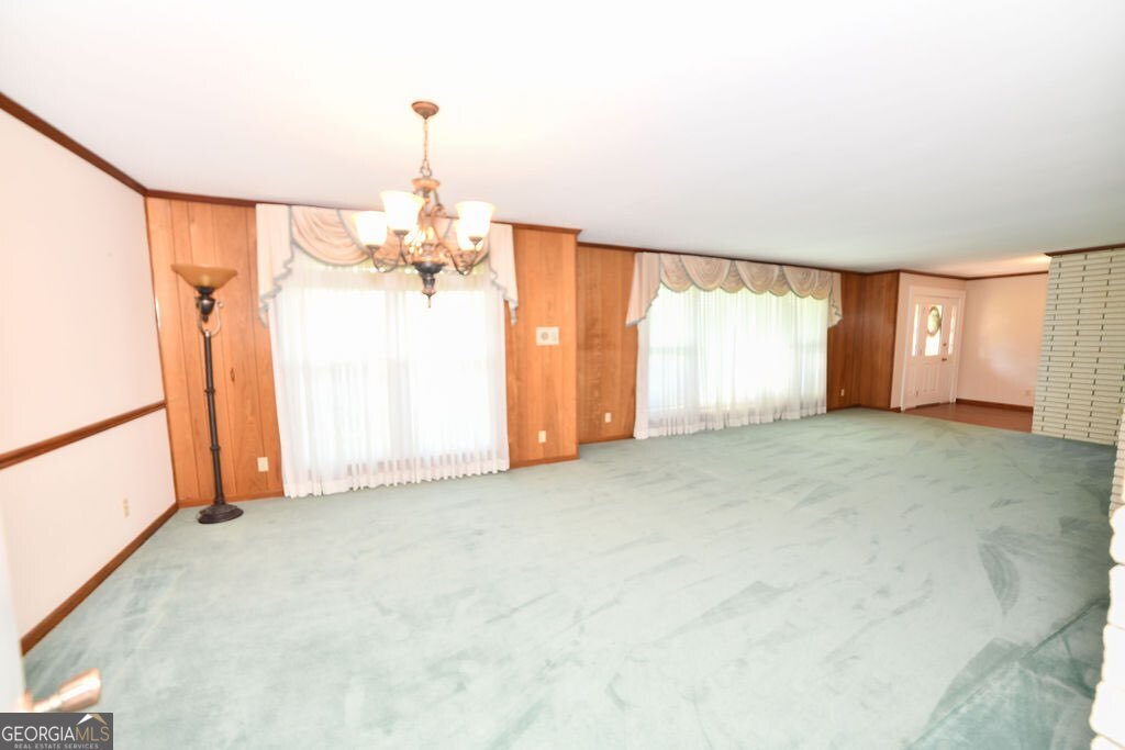 39 Adams Street Jesup, GA 31545 - Photo 27 of 49 a view of empty room with windows and chandelier