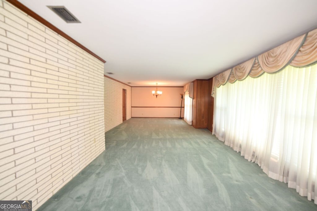 39 Adams Street Jesup, GA 31545 - Photo 29 of 49 a view of a room with a window and a ceiling fan