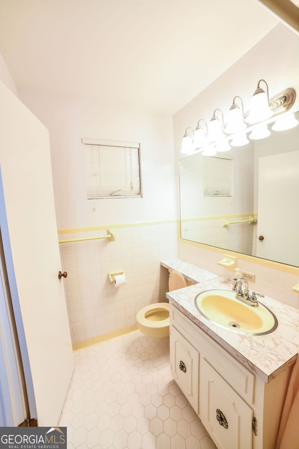 39 Adams Street Jesup, GA 31545 - Photo 38 of 49 a bathroom with a sink a toilet and mirror