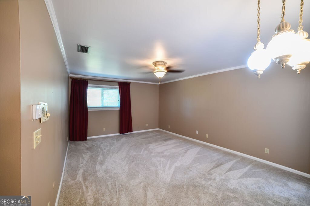 39 Adams Street Jesup, GA 31545 - Photo 39 of 49 a view of a big room with windows and chandelier