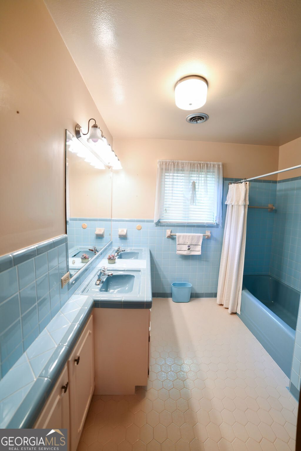 39 Adams Street Jesup, GA 31545 - Photo 46 of 49 a bathroom with a granite countertop sink a large mirror and a shower