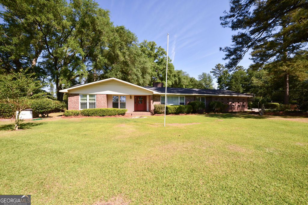 39 Adams Street Jesup, GA 31545 - Photo 49 of 49 a house view with swimming pool in front of it