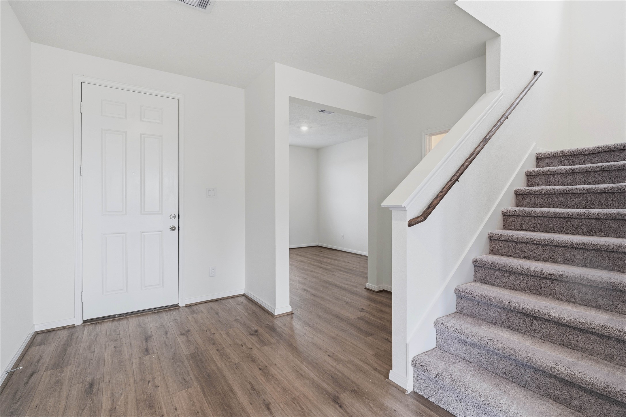 2503 Spruce Hl Road Beasley, TX 77417 - Photo 6 of 31 Walking in, you are greeted by high ceilings, neutral toned paint, gorgeous flooring, staircase leading to the second floor, and an intimate Den, located in the front of the home.