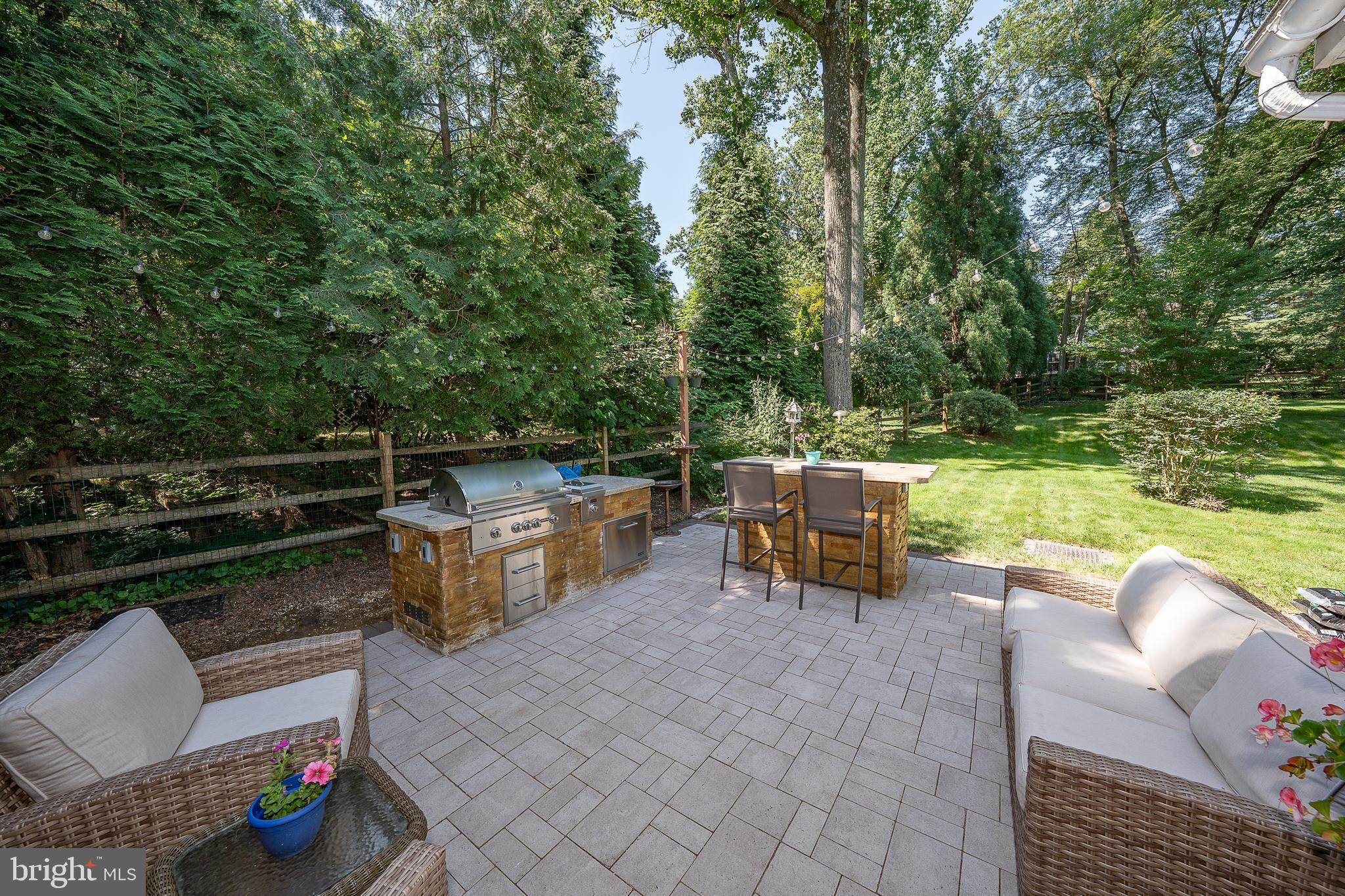 406 Devon State Road Devon, PA 19333 - Photo 7 of 14 a view of a patio with a table chairs and a fire pit