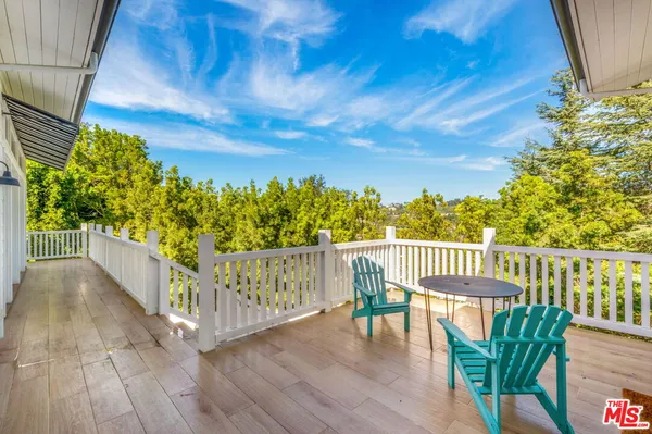 a view of a chair and table in the balcony