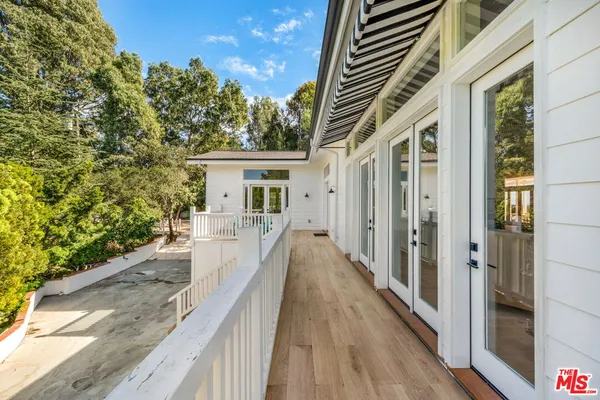 a bedroom with furniture and a flat screen tv