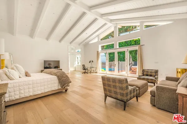 a view of a yard with wooden fence