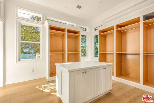 a living room with a bed furniture and a window