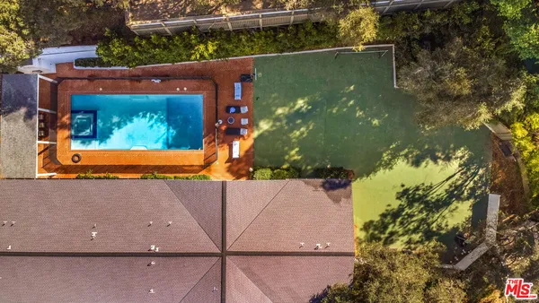 an aerial view of a house with a yard