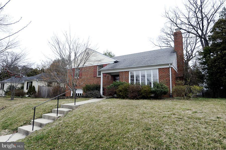 5719 Ogden Road Bethesda, MD 20816 - Photo 1 of 22 a view of a brick house with a big yard and large trees