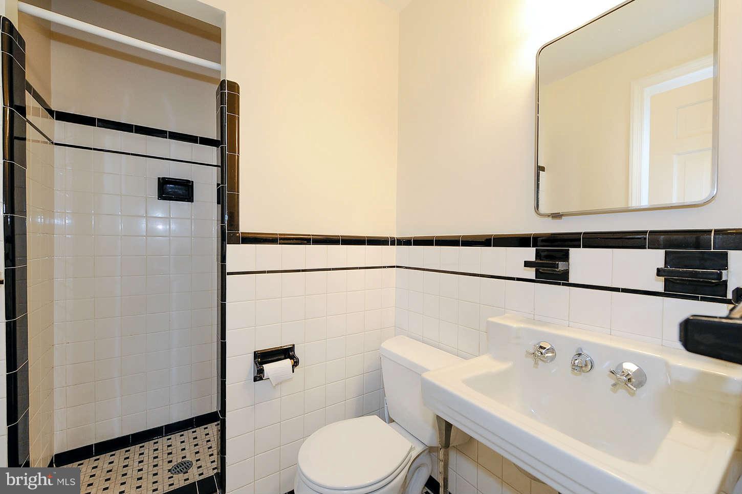 5719 Ogden Road Bethesda, MD 20816 - Photo 14 of 22 a bathroom with a sink a toilet and shower