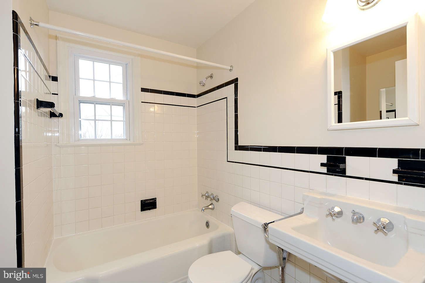 5719 Ogden Road Bethesda, MD 20816 - Photo 17 of 22 a bathroom with a sink and a mirror