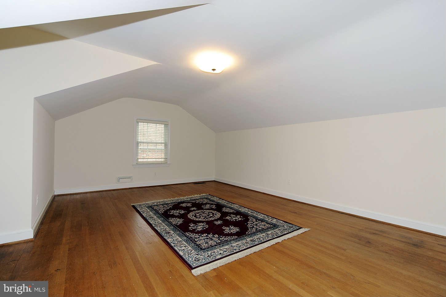 5719 Ogden Road Bethesda, MD 20816 - Photo 18 of 22 an empty room with wooden floor windows and closet