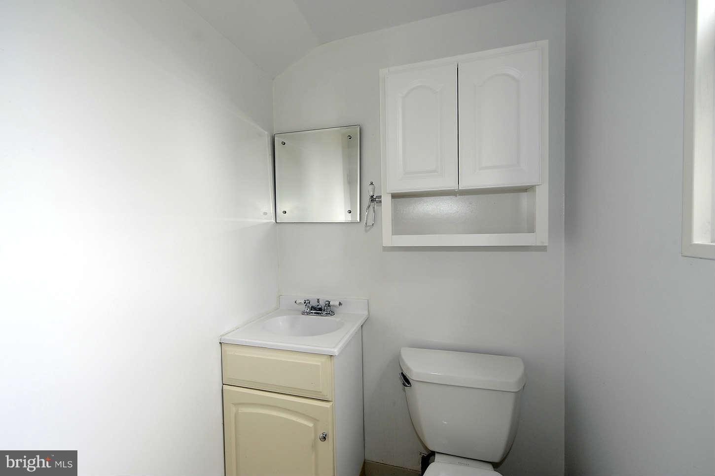5719 Ogden Road Bethesda, MD 20816 - Photo 20 of 22 a bathroom with a toilet sink and vanity
