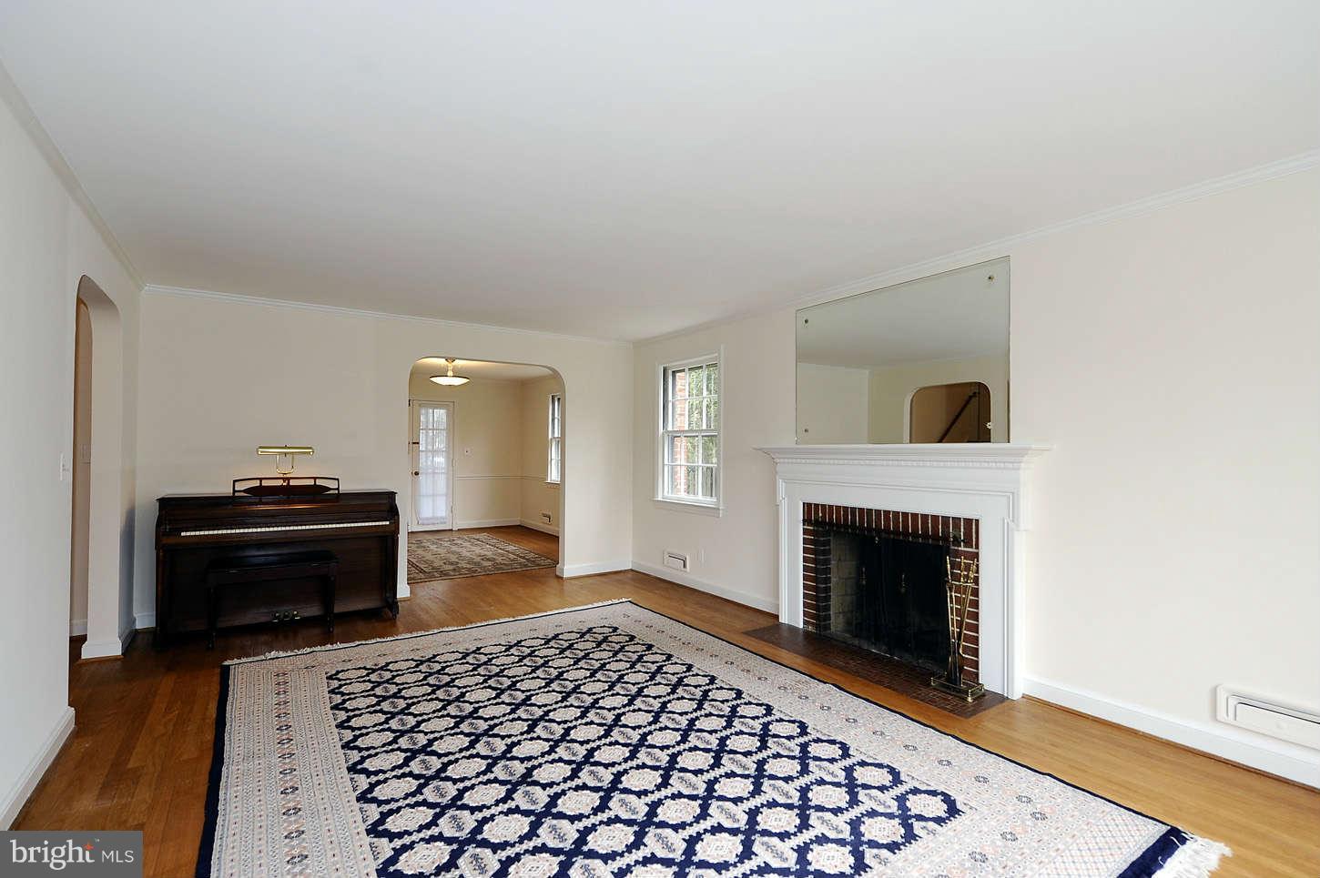5719 Ogden Road Bethesda, MD 20816 - Photo 7 of 22 a living room with a couch and a fireplace