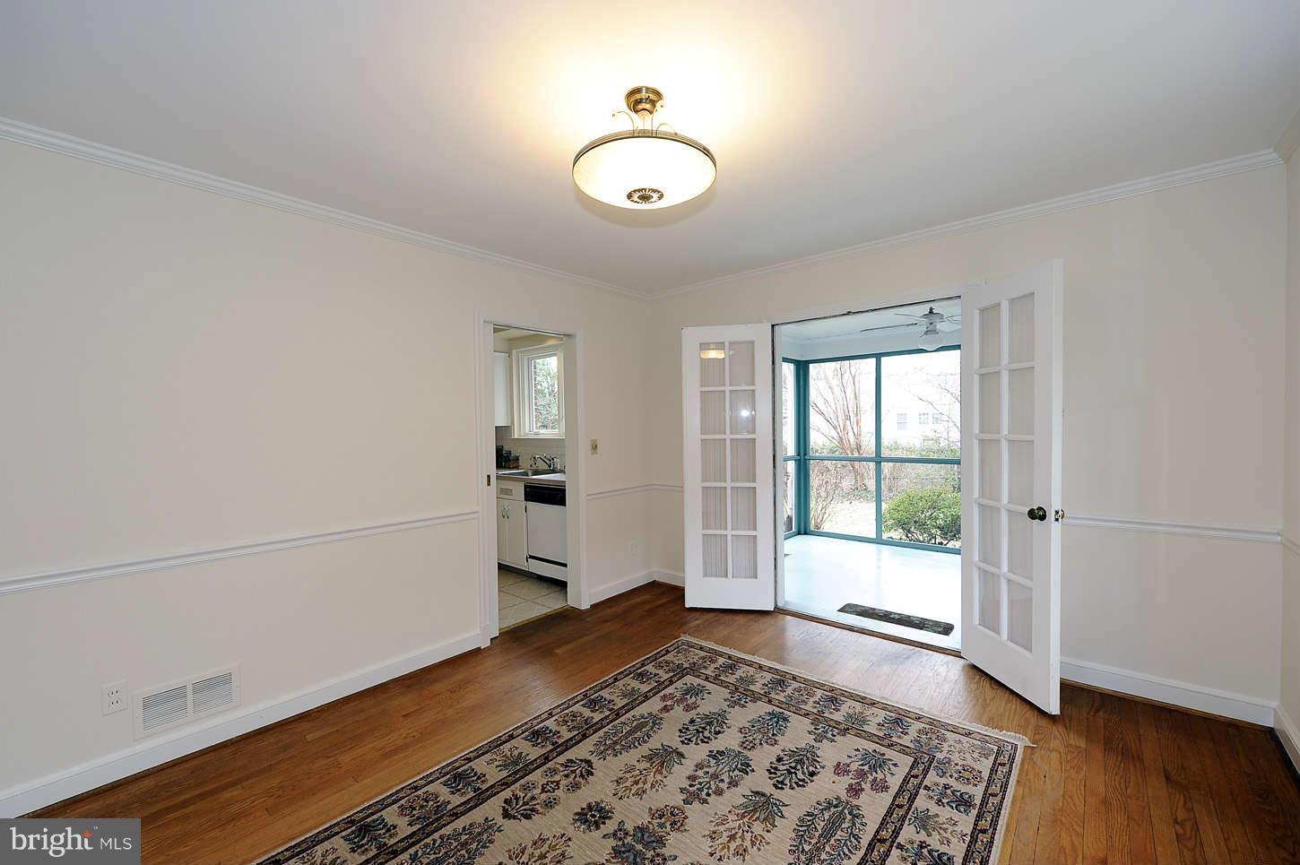 5719 Ogden Road Bethesda, MD 20816 - Photo 8 of 22 an empty room with wooden floor and windows